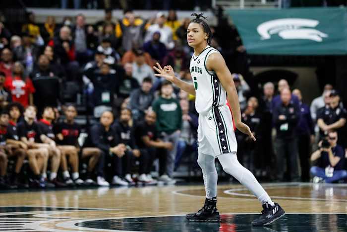 Detroit Cass Tech guard Darius Acuff celebrates a 3-point basket that tied the game at the end of the second half of Cass Tech's 62-56 overtime win in the Division 1 semifinal at Breslin Center on Friday, March 24, 2023.